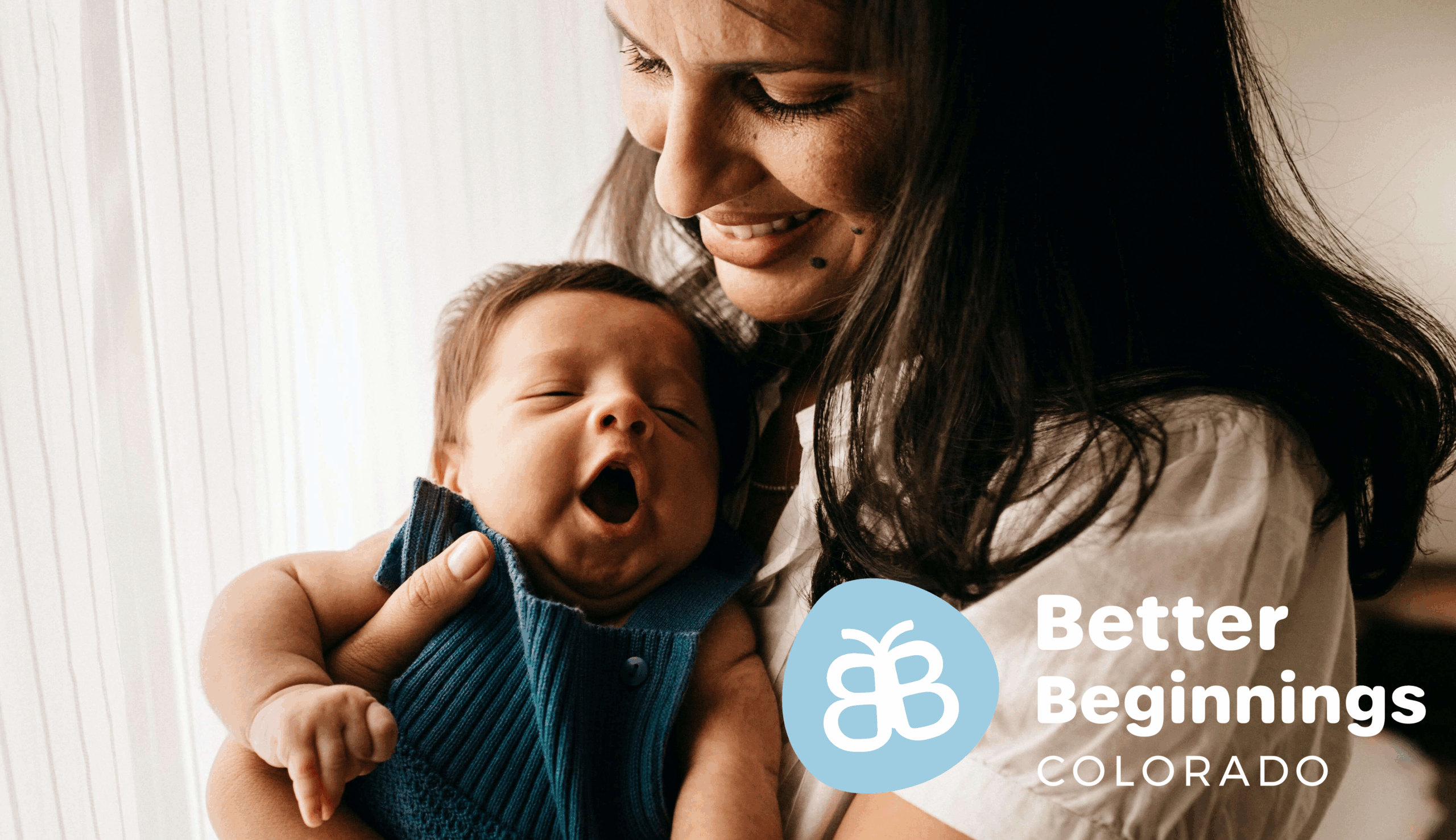 A smiling woman holds a yawning baby close to her chest, with the Better Beginnings Colorado logo and text displayed in the lower right corner.