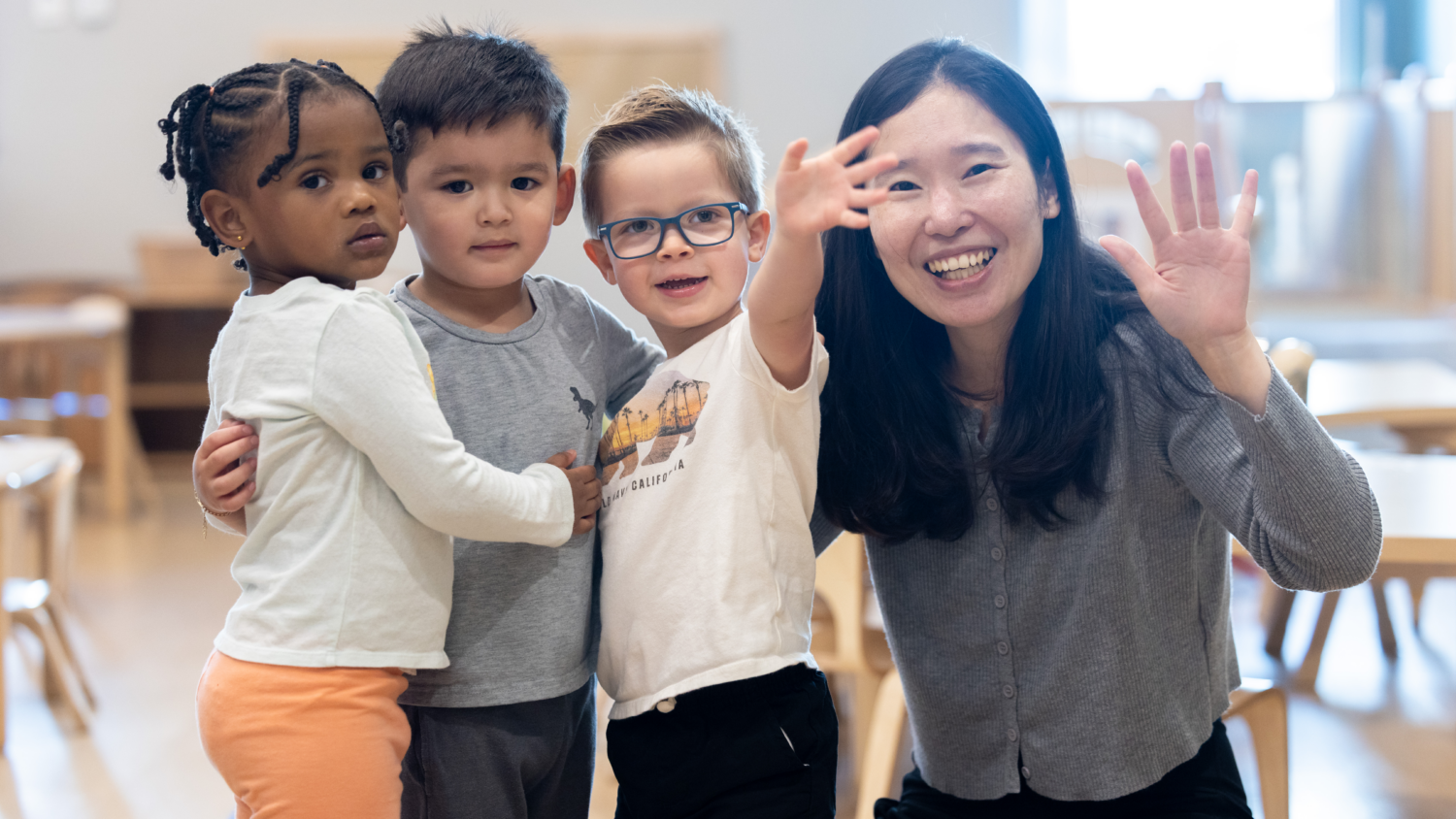 Three toddlers and their teacher