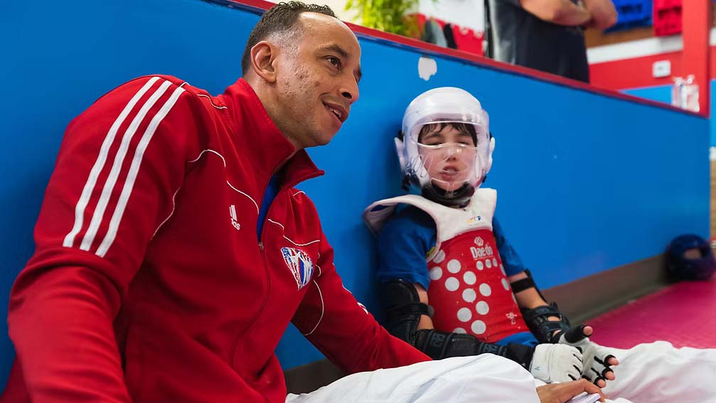 Master Yosvany talks with a young martial arts student